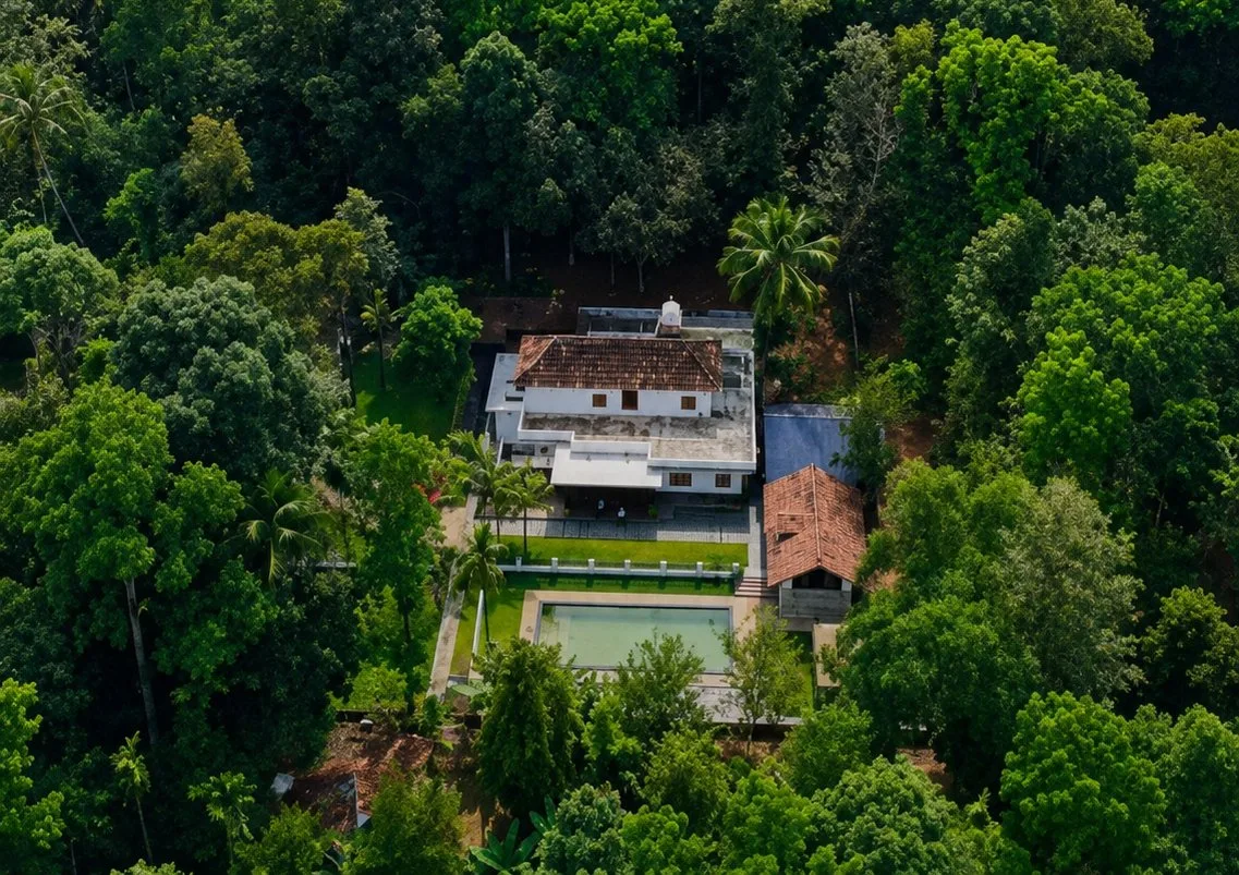Aerial view of Jeevika Haven villa nestled in the green forest of Kombanad