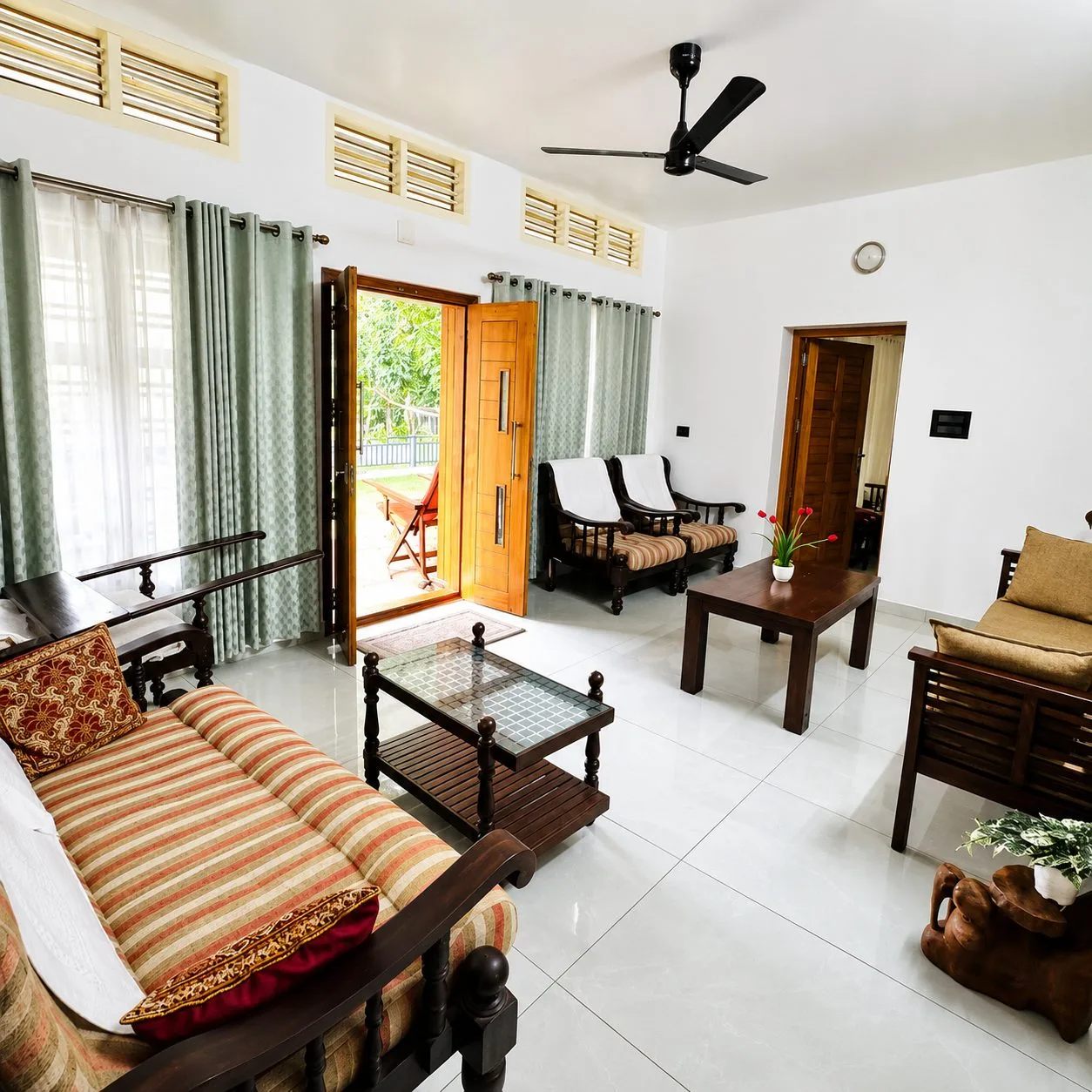 Sunlit living hall with elegant wooden furniture at Jeevika Haven