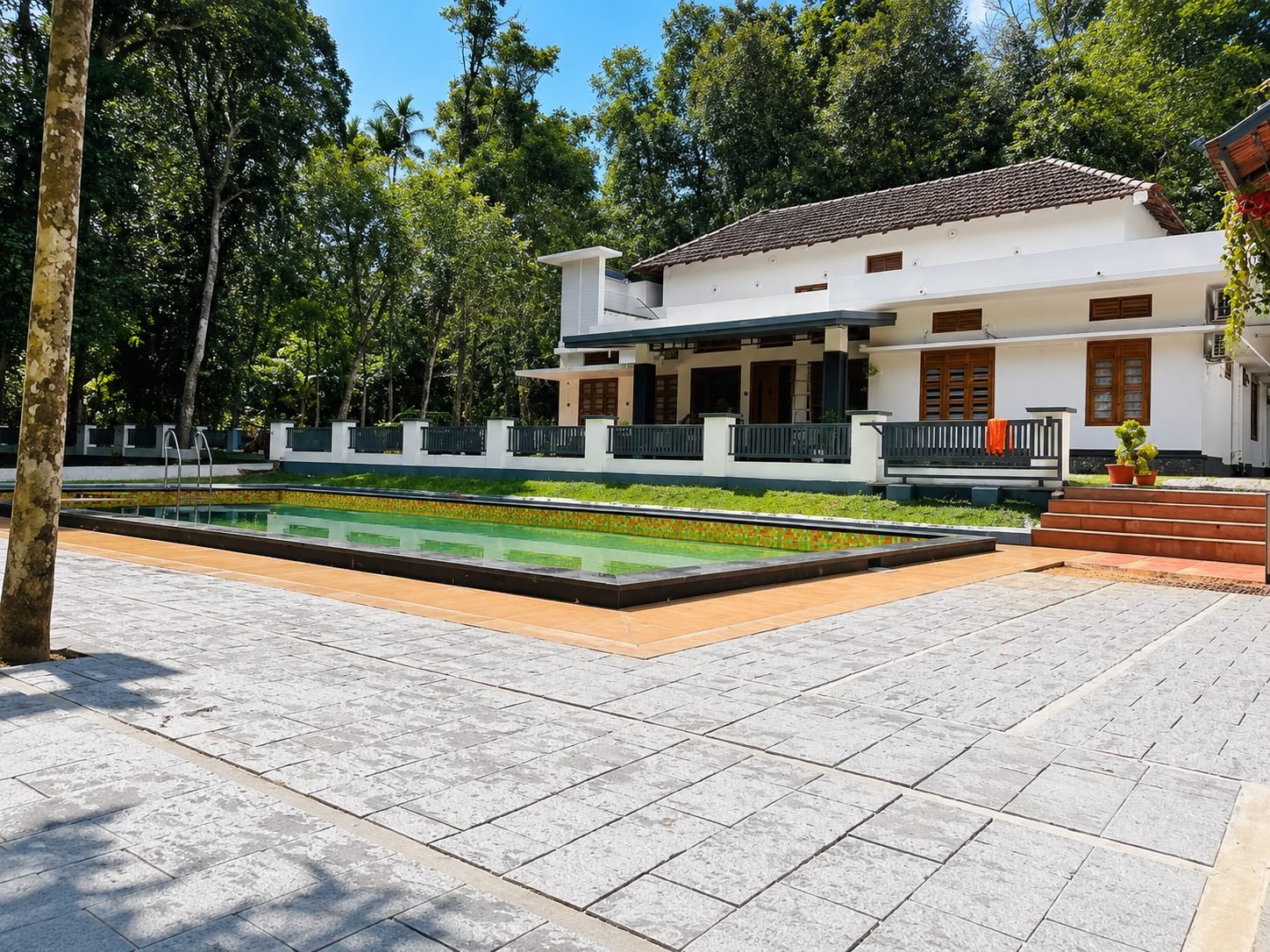Private swimming pool at Jeevika Haven with garden views